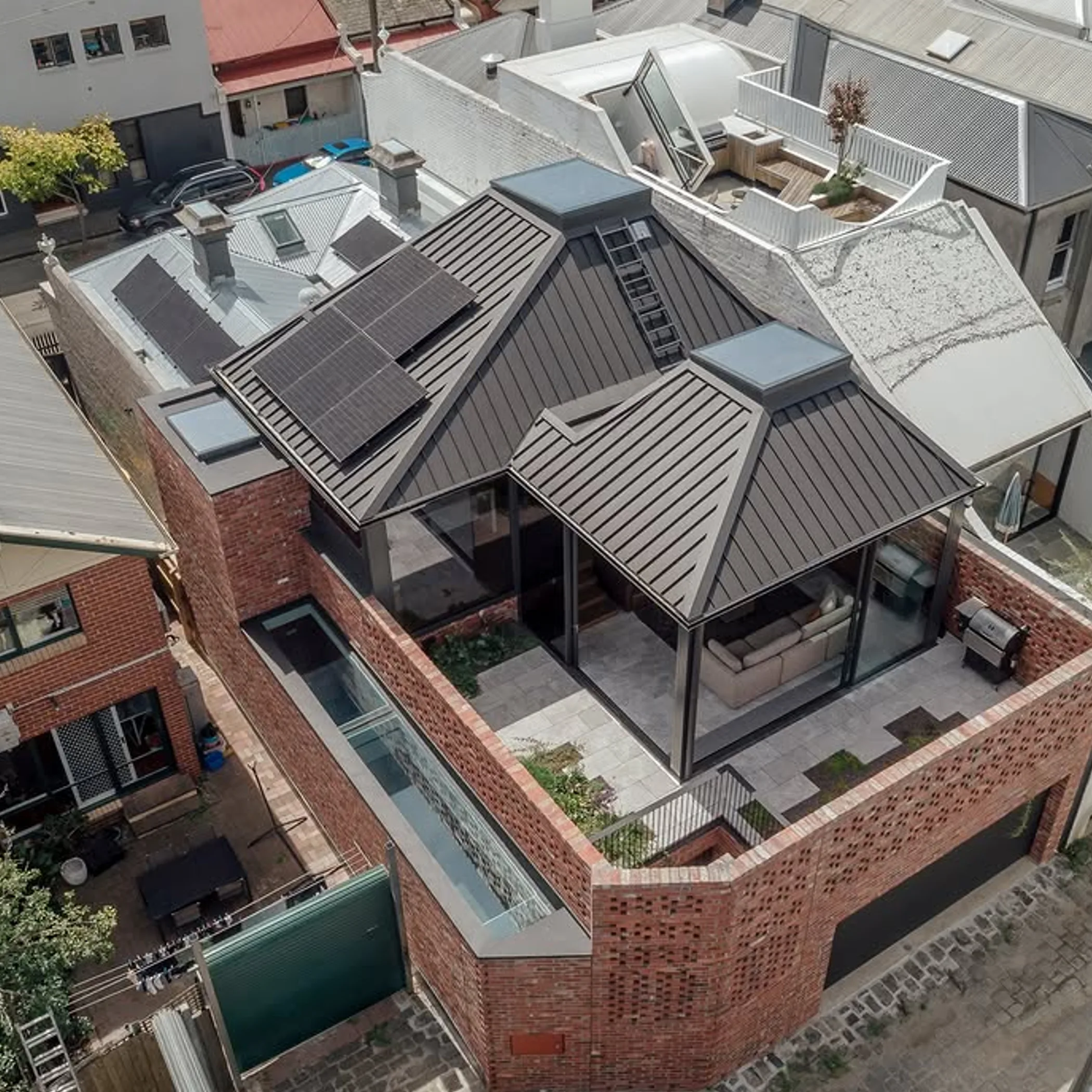 multi-pitch metal roof with skylights and solar panels